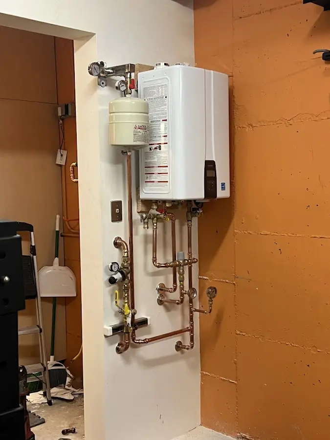 Plumbing technician inspecting water heater connections in Benicia